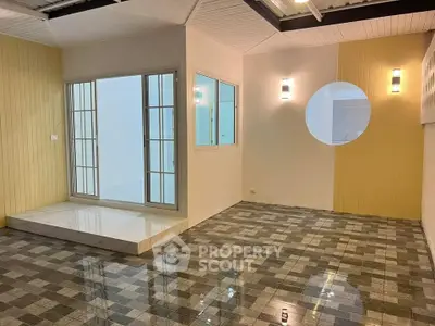 Modern interior with unique circular window and stylish tile flooring.