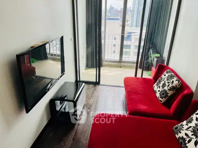 Modern living room with red sofas and city view balcony, perfect for urban living.