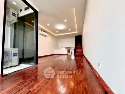 Spacious modern living room with wooden flooring and recessed lighting