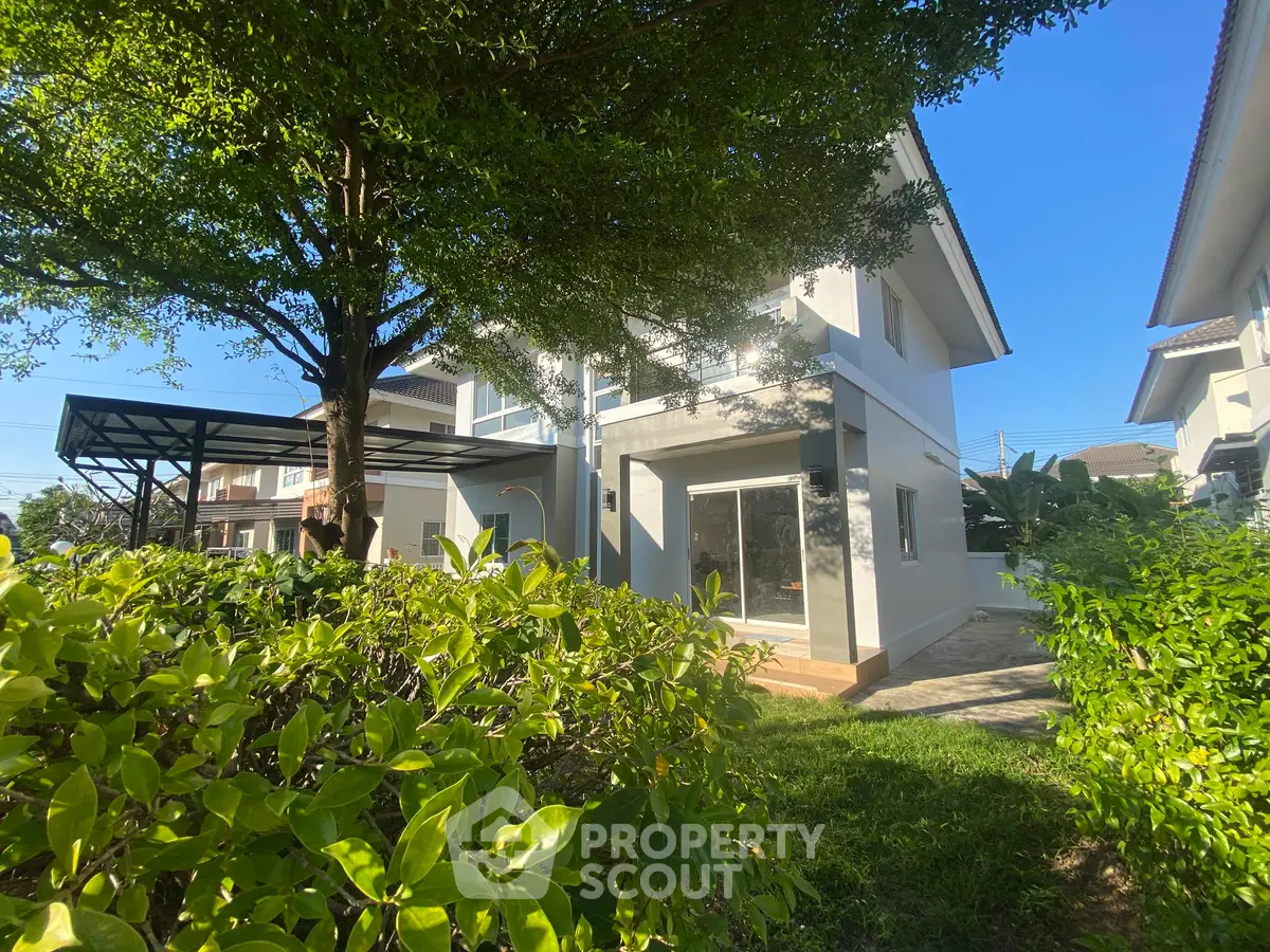 Charming two-story house with lush garden and modern design in a serene neighborhood.