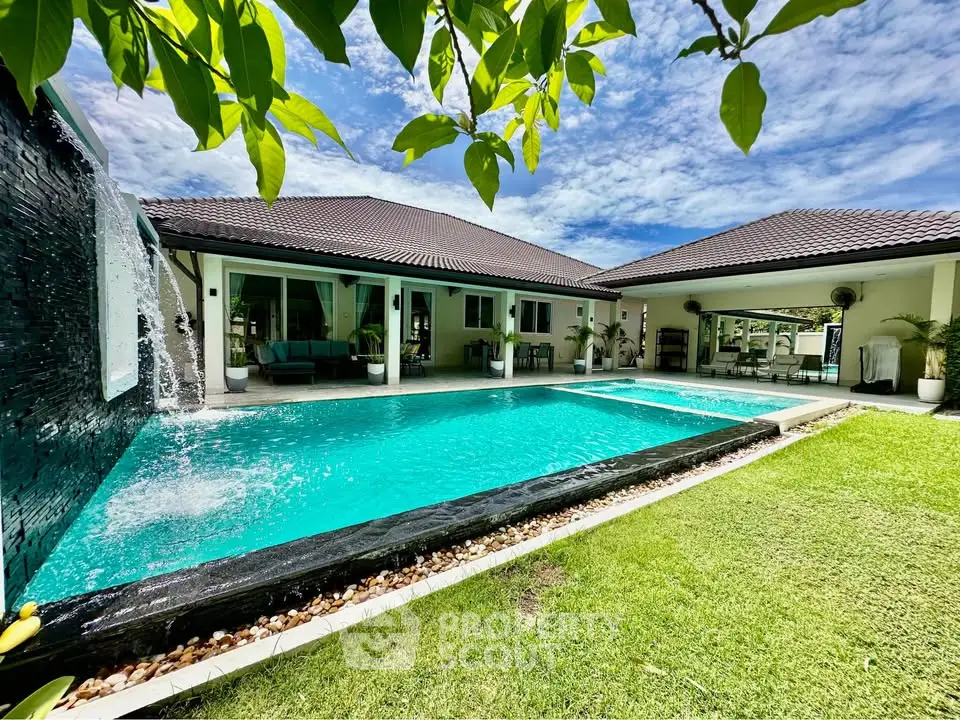 Luxurious villa with stunning pool and lush garden, perfect for relaxation and entertainment.
