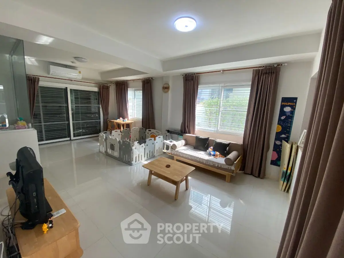 Spacious living room with modern decor and large windows for natural light.