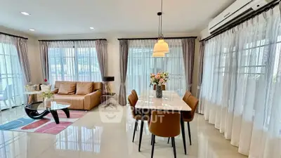 Spacious living and dining area with modern decor and ample natural light.