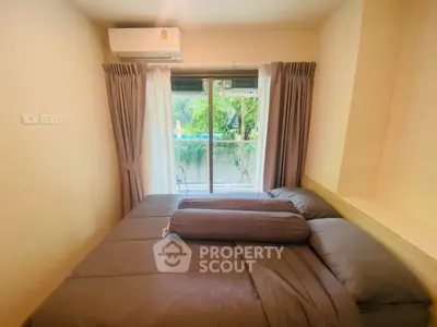 Cozy bedroom with large window and garden view, featuring modern air conditioning and elegant curtains.