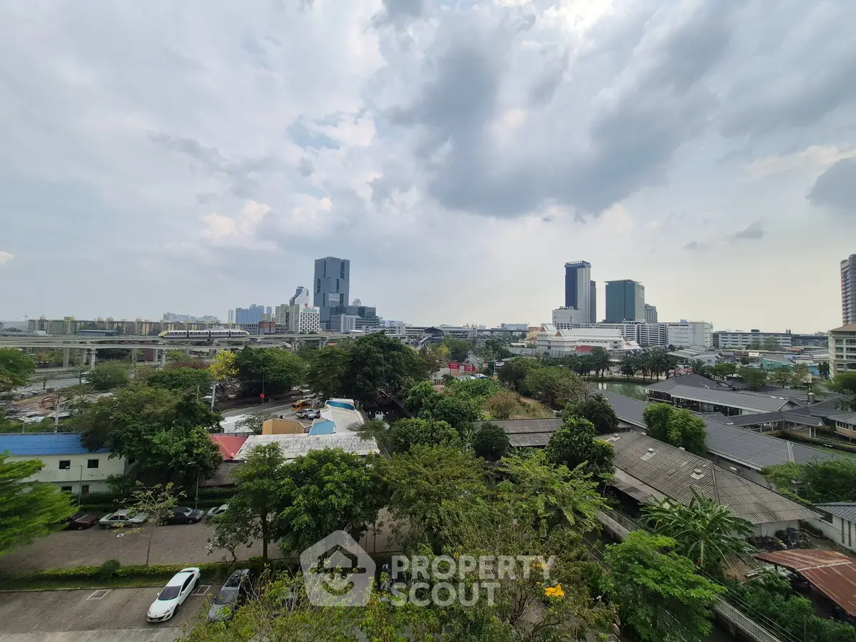 Stunning cityscape view with lush greenery and modern buildings, perfect for urban living enthusiasts.