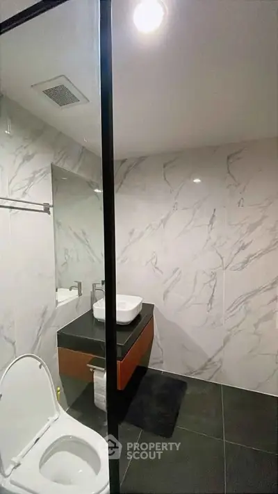Modern bathroom with sleek marble walls and contemporary fixtures