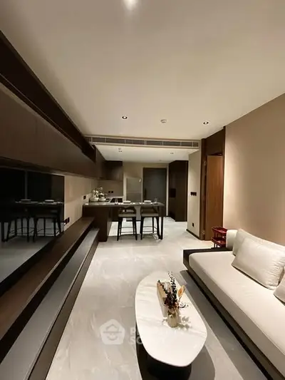 Modern living room with sleek design and open kitchen layout