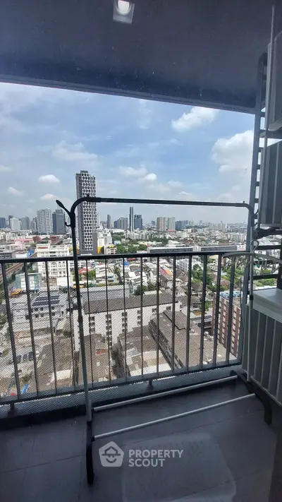 Stunning cityscape view from a high-rise balcony with ample space for relaxation.