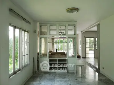 Spacious living room with large windows and elegant marble flooring