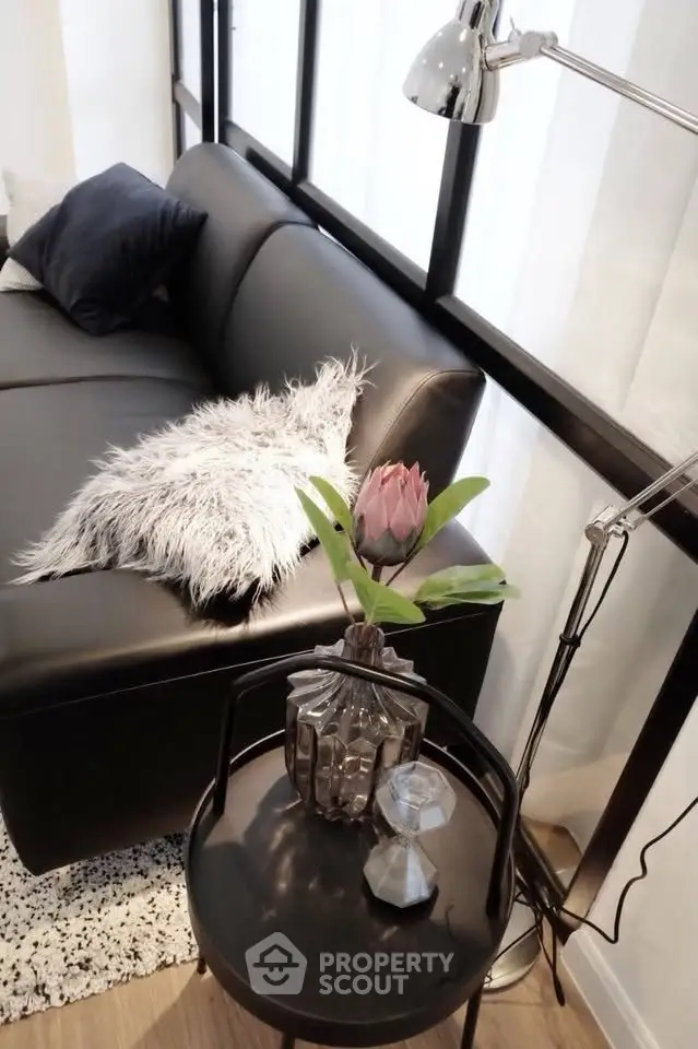 Stylish modern living room with sleek black sofa and chic decor accents