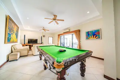 Spacious living room with pool table and modern decor