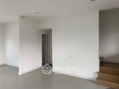 Spacious modern interior with minimalist design and wooden staircase