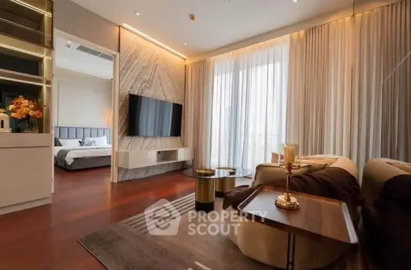 Luxurious modern living room with elegant decor and open view to bedroom, featuring stylish furniture and ambient lighting.