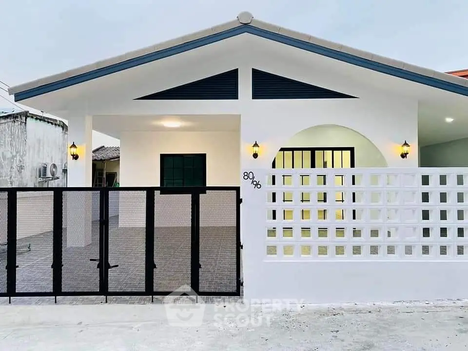 Charming single-story house with modern facade and gated entrance