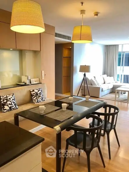 Modern open-plan living and dining area with stylish furniture and natural lighting.