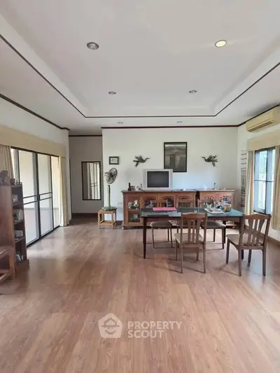 Spacious living room with wooden flooring and elegant decor