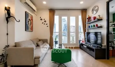 Stylish living room with modern decor and city view from large windows.