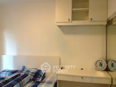 Cozy bedroom with modern furniture and stylish decor, featuring a comfortable bed and ample storage space.