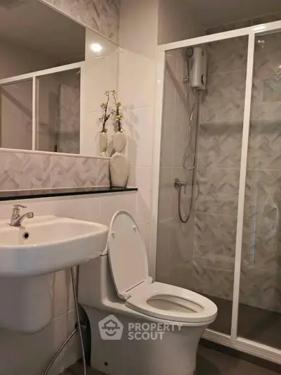 Modern bathroom with shower and elegant decor in a stylish apartment.