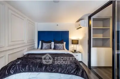 Modern bedroom with plush bedding and built-in storage, featuring elegant lighting and sleek design.