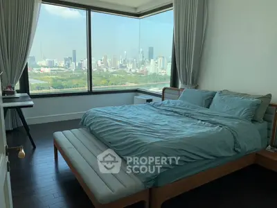 Luxurious bedroom with stunning city view and modern furnishings.