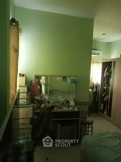 Cozy bedroom with ample storage and natural light, perfect for relaxation.