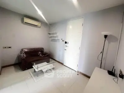 Modern living room with sleek furniture and air conditioning, perfect for cozy urban living.