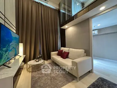Modern living room with high ceilings and elegant decor in a stylish apartment.