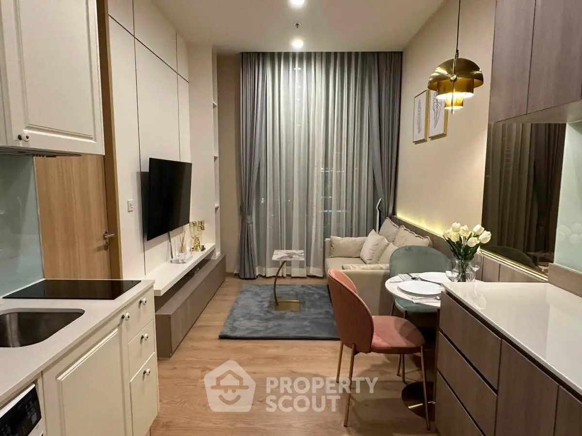 Modern open-layout kitchen and living room with stylish decor and cozy ambiance.