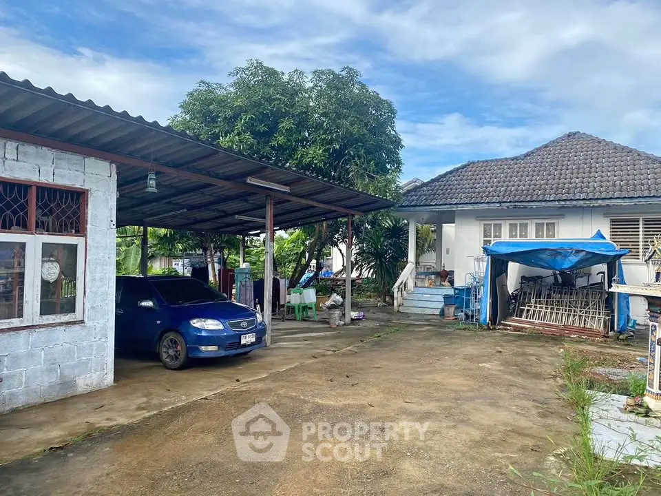 Charming suburban home with spacious driveway and carport, perfect for family living.