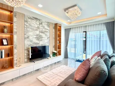 Luxurious living room with modern decor, plush sofa, and elegant lighting in a stylish home.