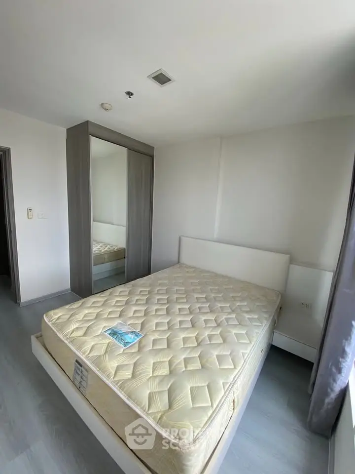 Modern bedroom with sleek wardrobe and comfortable bed in a bright apartment