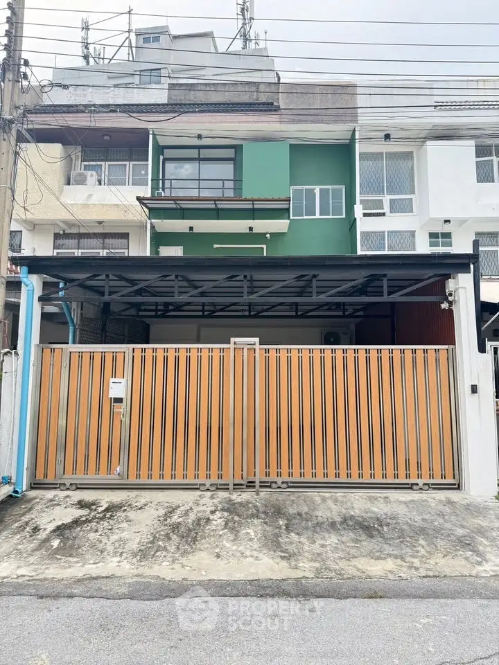 Modern townhouse with secure gated entrance and contemporary facade.