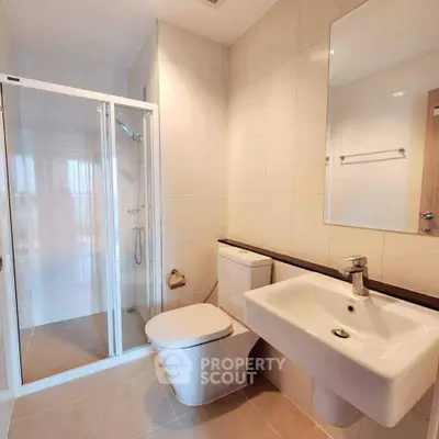 Modern bathroom with sleek fixtures and glass shower enclosure