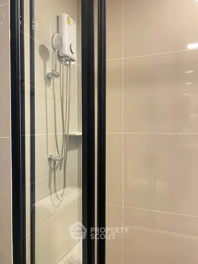 Modern bathroom shower with sleek glass doors and contemporary fixtures.
