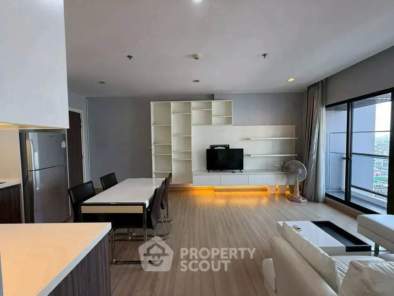 Spacious modern living room with dining area and city view balcony