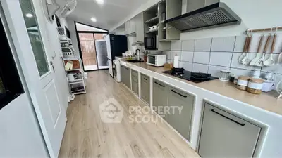Modern kitchen with sleek cabinets and gas stove in open layout