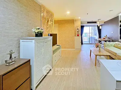 Spacious modern living room with elegant decor and open layout, featuring stylish furniture and natural light.