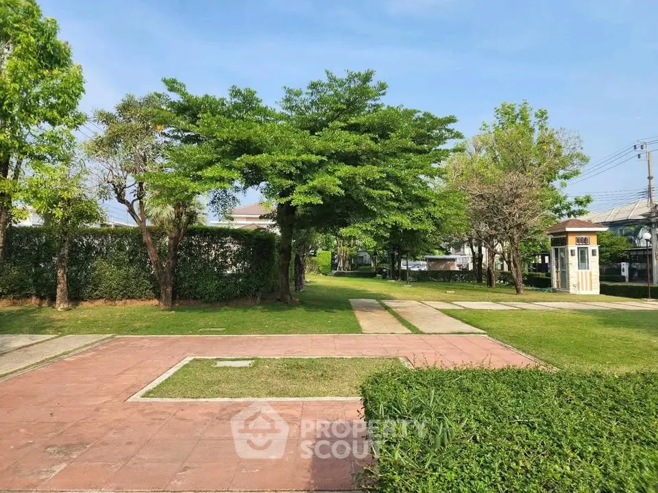 Lush green garden with paved walkways in a serene residential area.