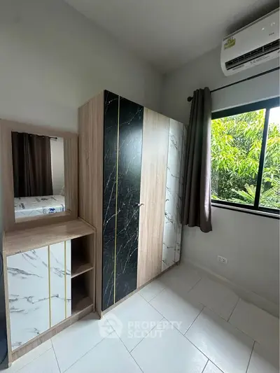 Modern bedroom with stylish wardrobe and natural light from window