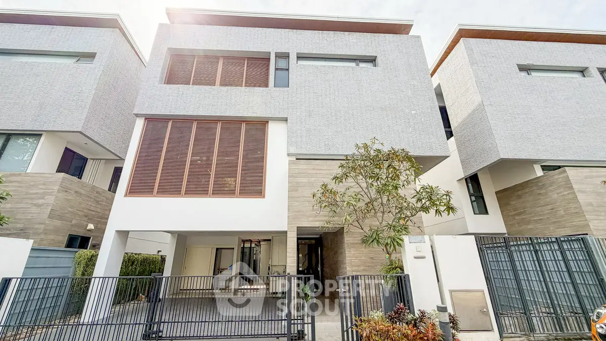 Modern townhouse exterior with sleek design and gated entrance