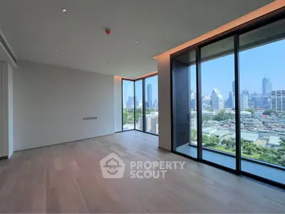 Spacious modern living room with floor-to-ceiling windows offering stunning city views.