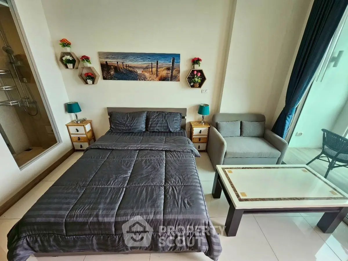 Modern bedroom with stylish decor and cozy seating area, perfect for relaxation.