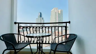 Charming balcony with city skyline view, perfect for relaxation and enjoying urban scenery.