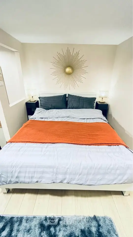 Cozy bedroom with stylish decor and plush bedding