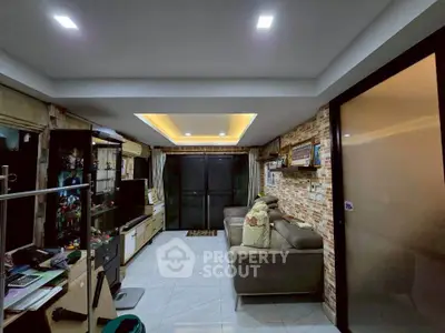 Spacious living room with modern decor and ambient lighting, perfect for relaxation and entertainment.