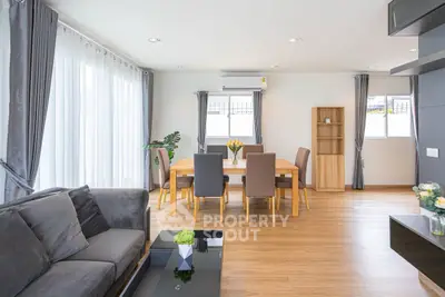 Spacious modern living and dining area with elegant decor and natural light.