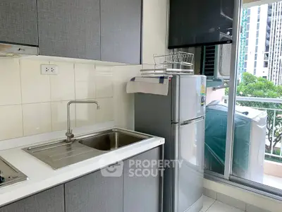 Modern kitchen with sleek cabinets and balcony view