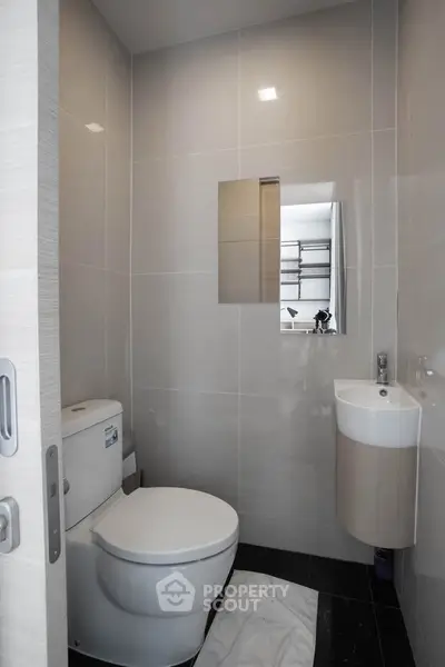Modern compact bathroom with sleek fixtures and minimalist design