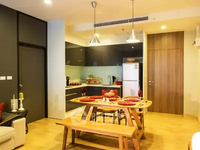 Modern kitchen with open layout and stylish dining area in a cozy apartment.